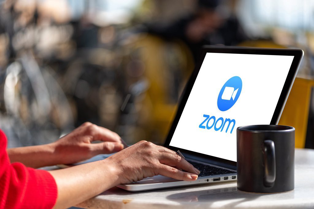 Computer showing Zoom Cloud Meetings app logo.