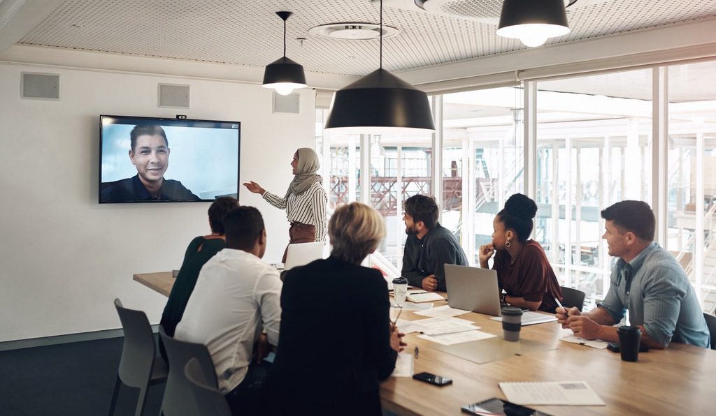 Workshop for employees showing benefits of new video conference technology and increasing confidence in hybrid work.