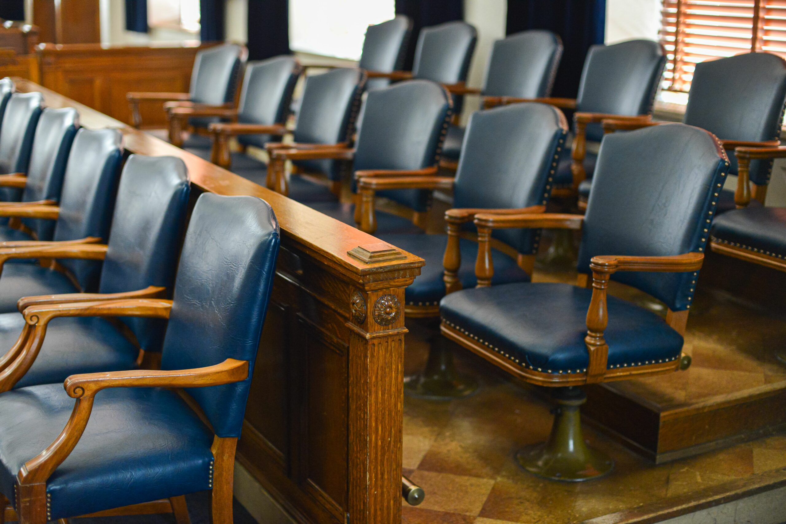 Empty jury box with blue leather chairs