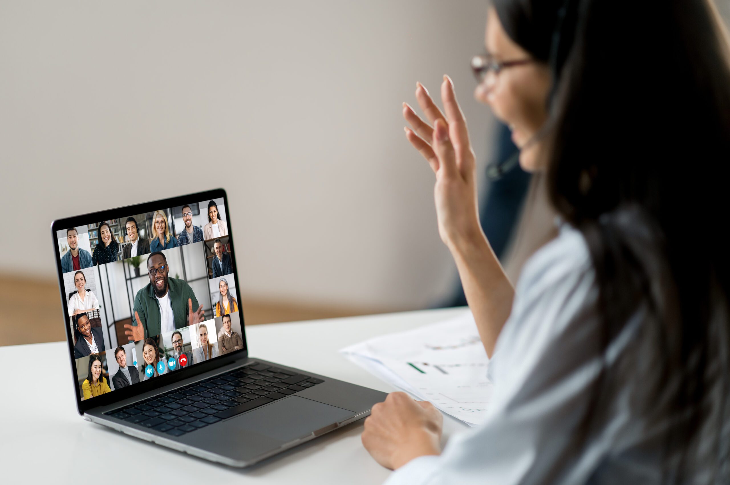 a woman attending a meeting virtually on her laptop 